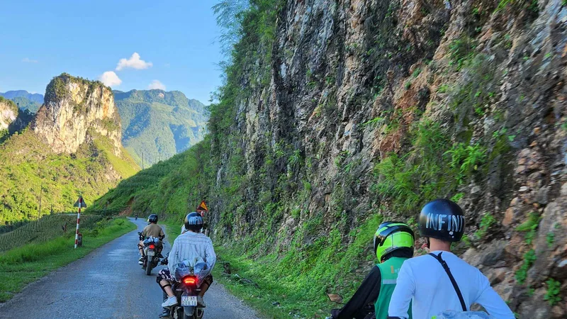 Two Easy Rider motorbikes on a cliffside road on a 4-day Vietnam tour package, the Ha Giang Loop from Hanoi, Ha Giang, Vietnam