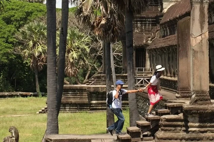 Visitors climbing the temple steps at Angkor Wat on a 12-day Vietnam tour package from Hanoi to Siem Reap, Angkor, Cambodia